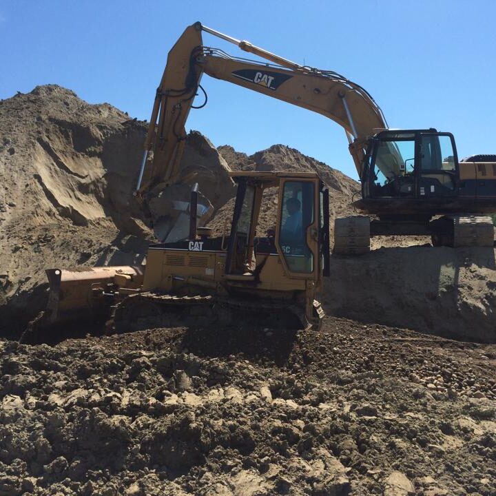 excavating aggregate materials with back hoe and bobcat